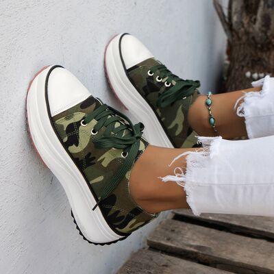 a woman's feet wearing green camouflage sneakers