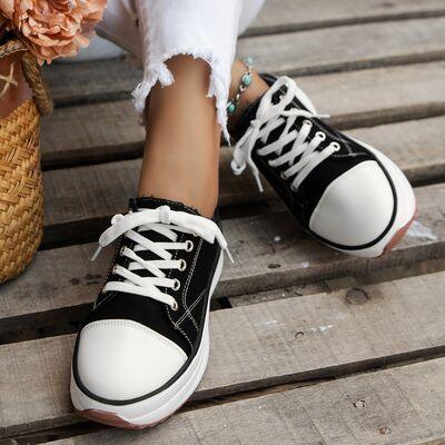 a close up of a person wearing black and white sneakers