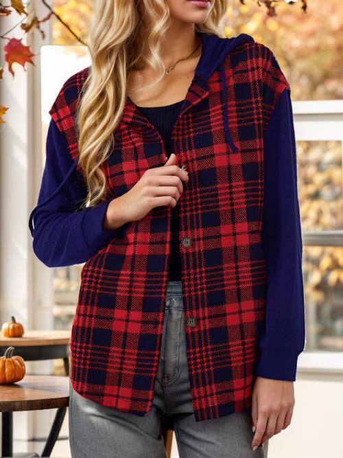 a woman wearing a red and black plaid vest