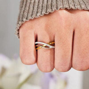 a close up of a person's hand with a ring on it