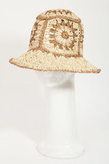 a white mannequin head wearing a straw hat