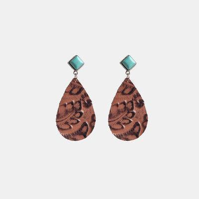 a pair of brown and turquoise earrings