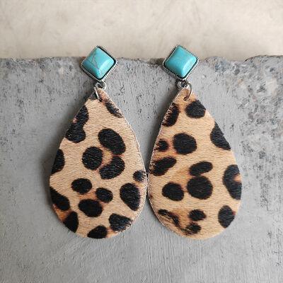 a pair of leopard print and turquoise stone earrings