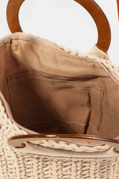 a handbag with a wooden handle is shown