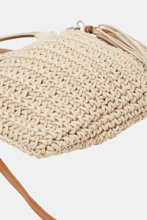 a crocheted purse with a leather strap