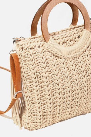a straw bag with a wooden handle on a white background