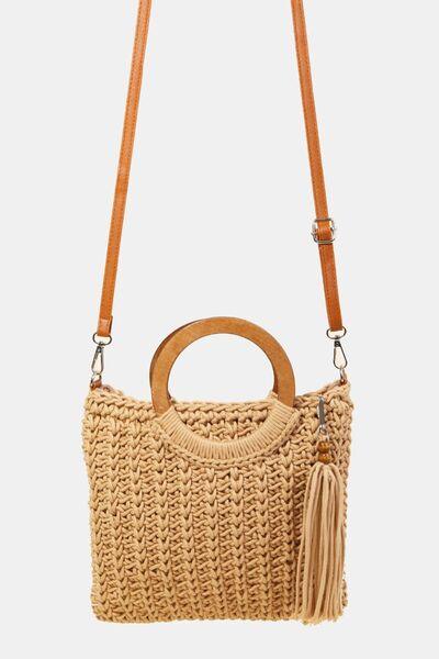 a straw bag with a wooden handle