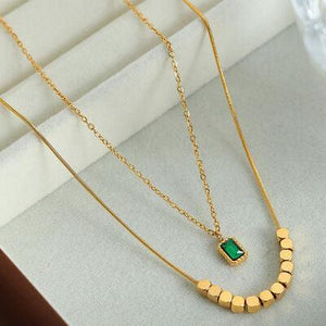 a necklace with a green stone on it