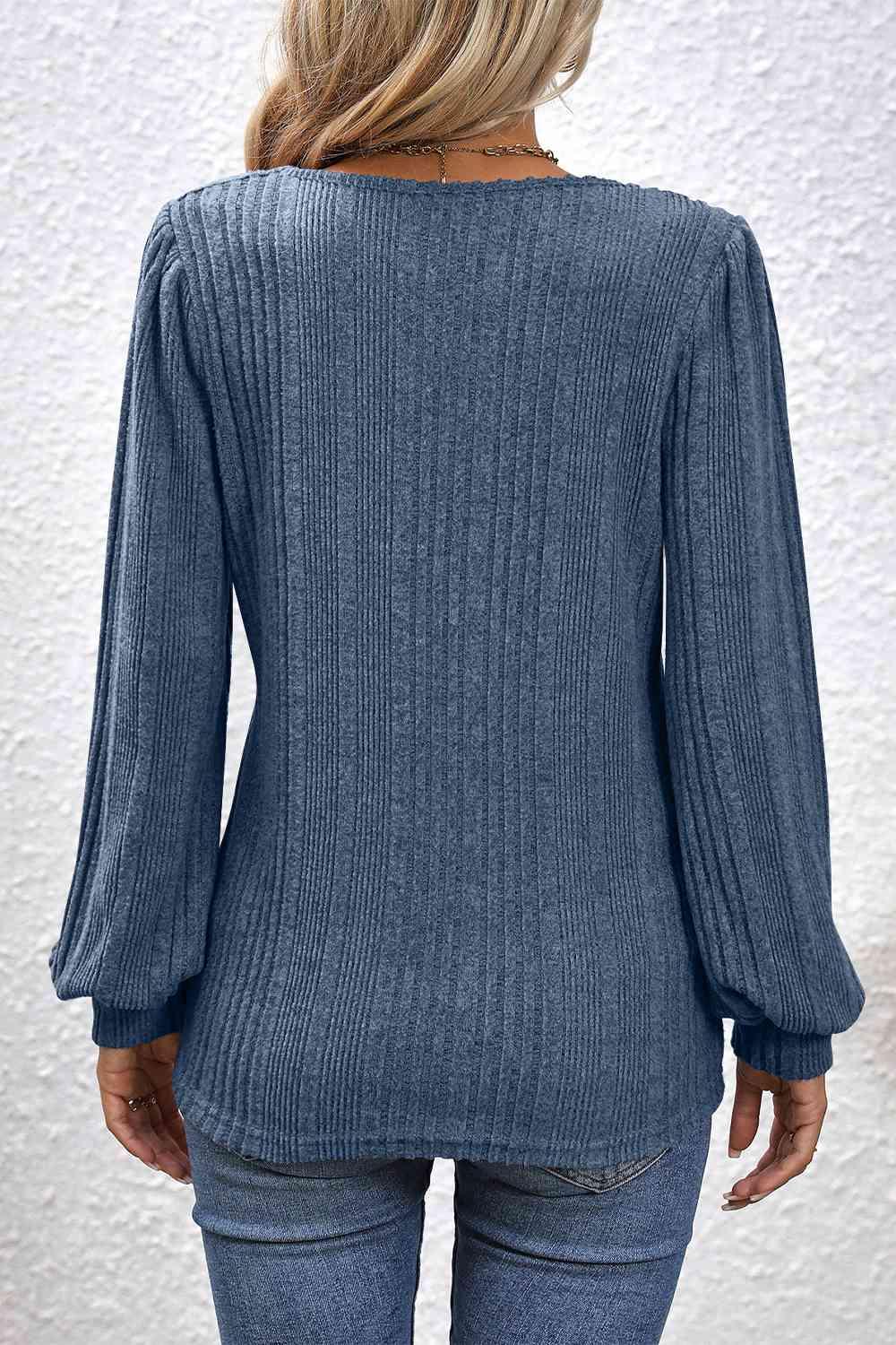 a woman wearing a blue sweater and jeans