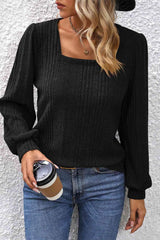 a woman wearing a black sweater and jeans