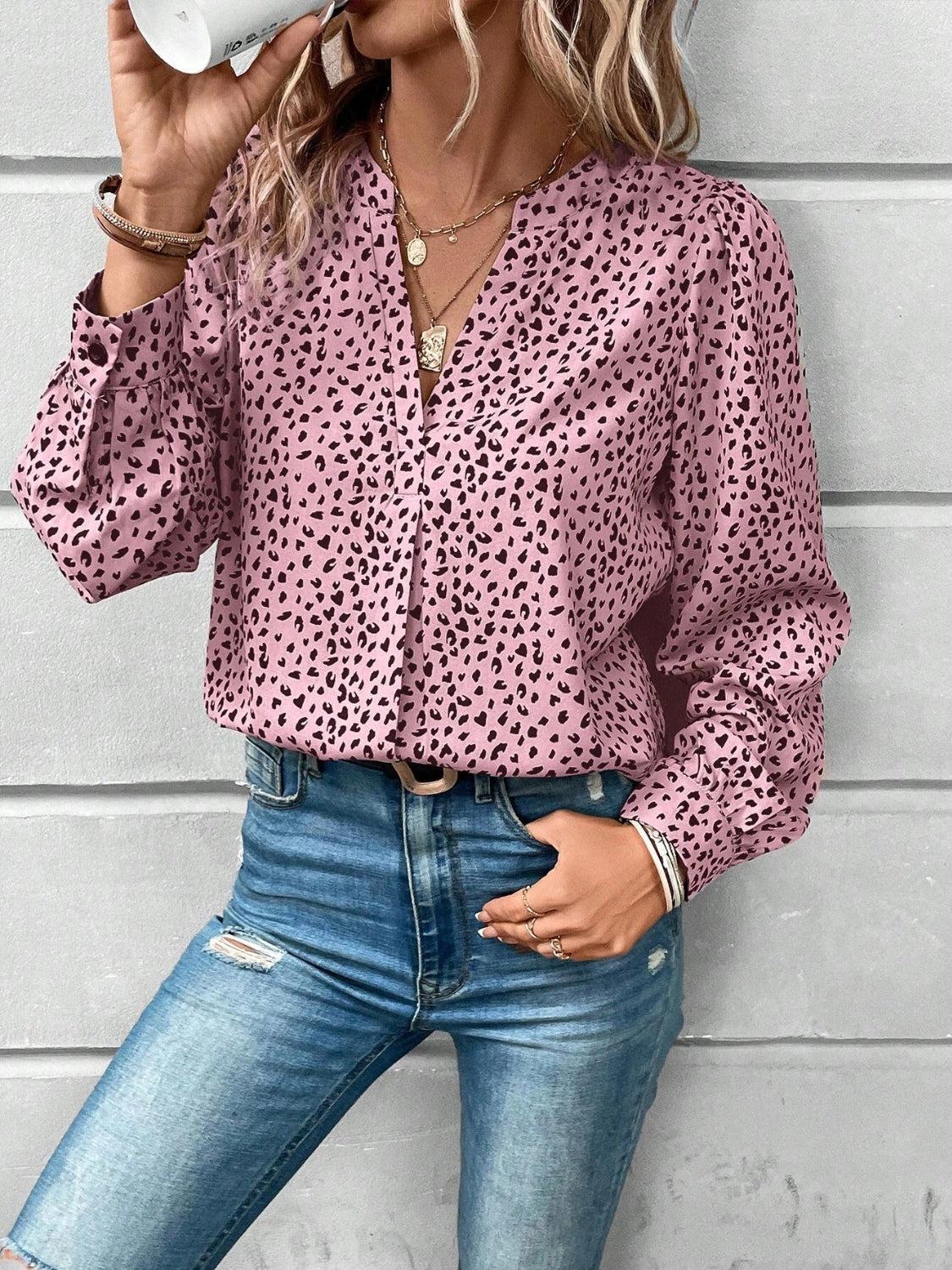 a woman wearing a pink shirt and jeans drinking from a cup