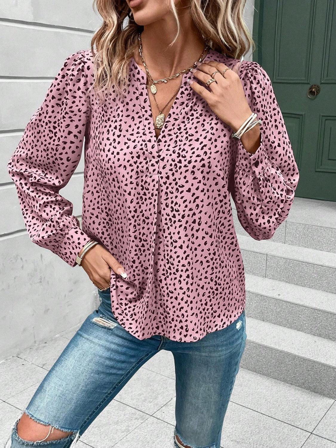 a woman wearing a pink top with a leopard print