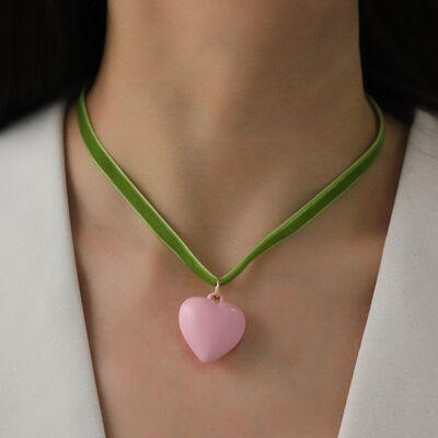 a woman wearing a pink heart shaped necklace
