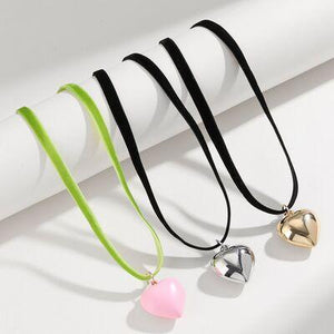 three heart shaped pendants on a black cord