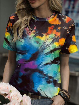 a woman wearing a colorful tie dye t - shirt