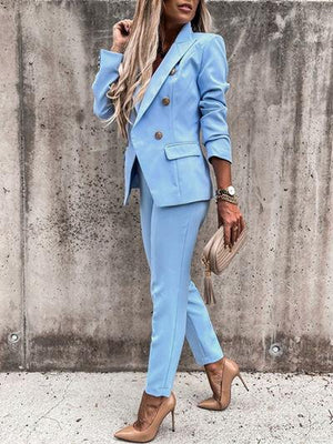 a woman wearing a blue suit and heels