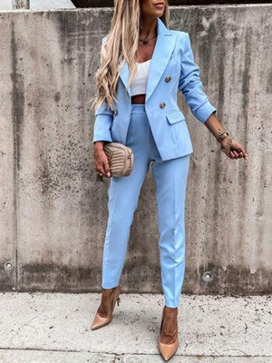 a woman wearing a blue suit and heels