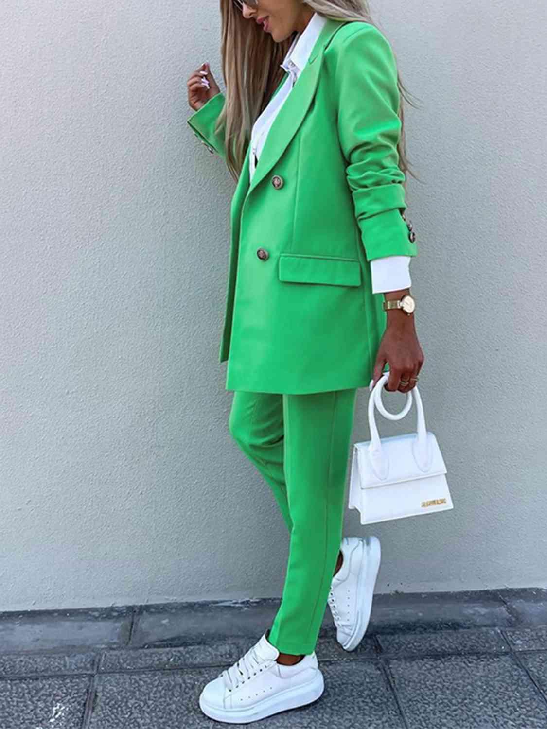 a woman wearing a green suit and white shoes