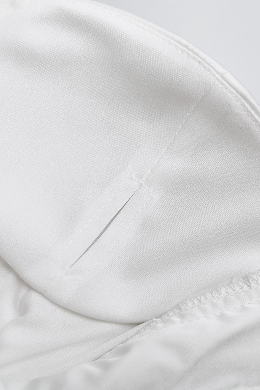 a close up of a white jacket with a zipper