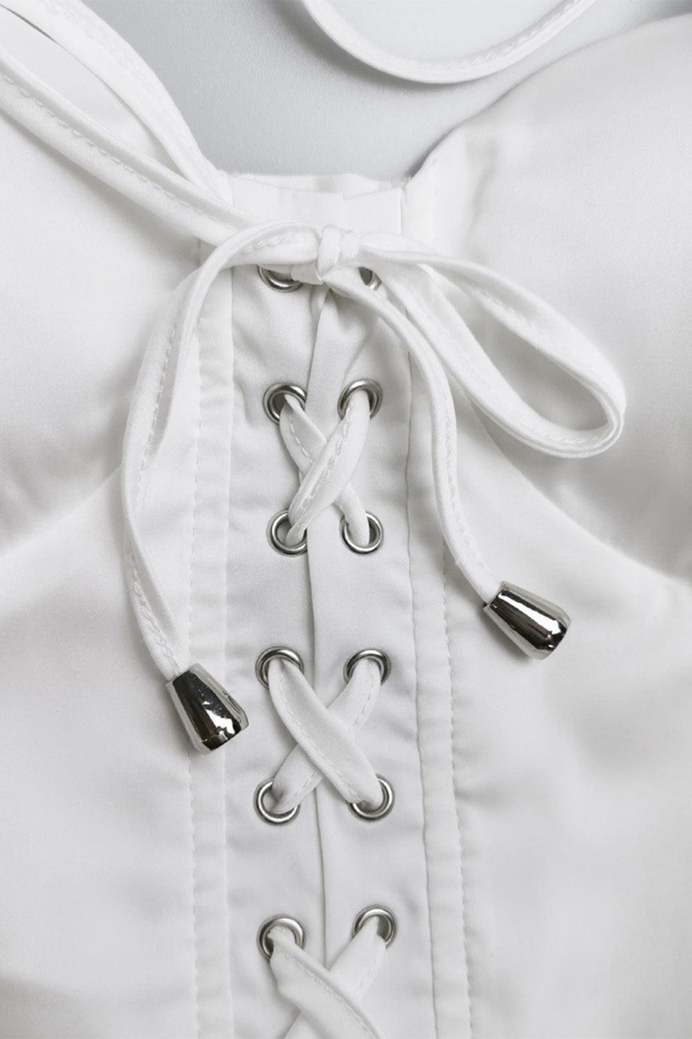 a close up of a corset on a white dress