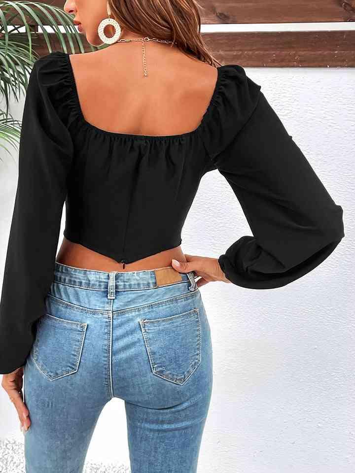 a woman wearing a black top and jeans