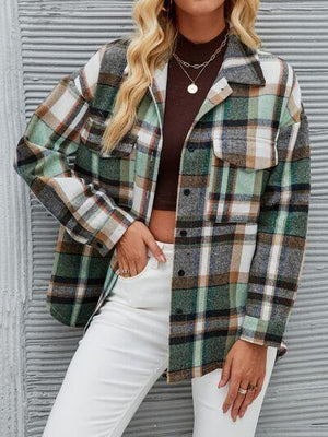 a woman wearing a plaid jacket and white pants