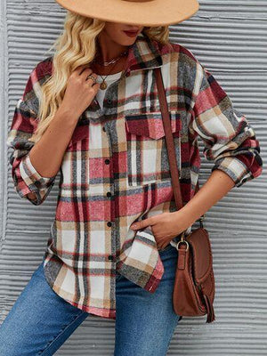 a woman wearing a hat and a plaid shirt