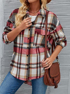 a woman wearing a hat and a plaid shirt