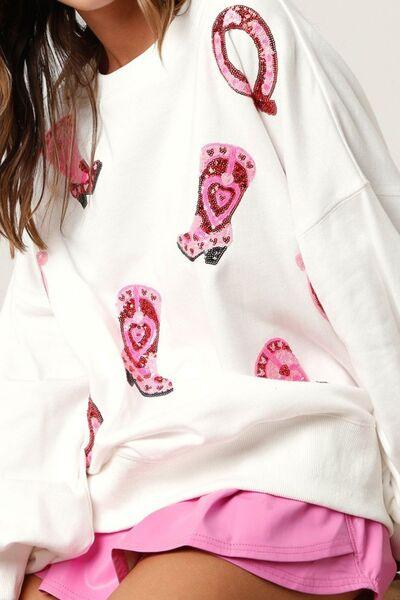 a woman wearing a white shirt with pink hearts on it