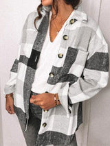 a woman wearing a white and black checkered jacket