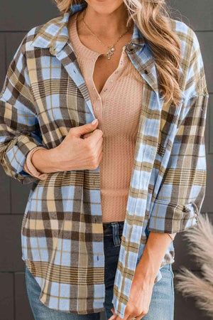 a woman wearing a plaid shirt and jeans