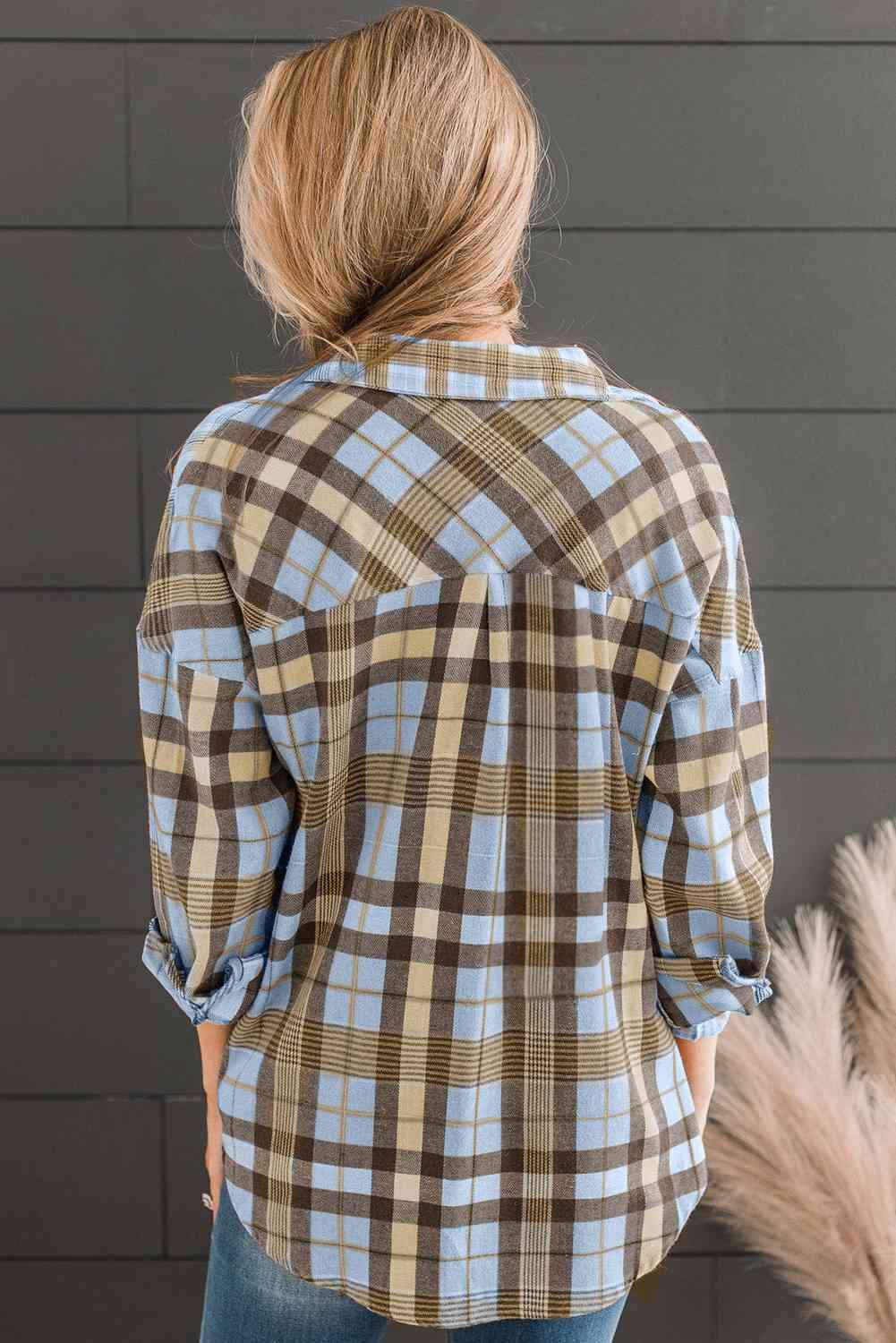 a woman wearing a brown and blue plaid shirt