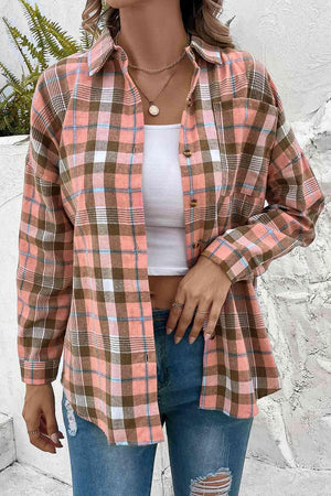 a woman wearing a plaid shirt and ripped jeans