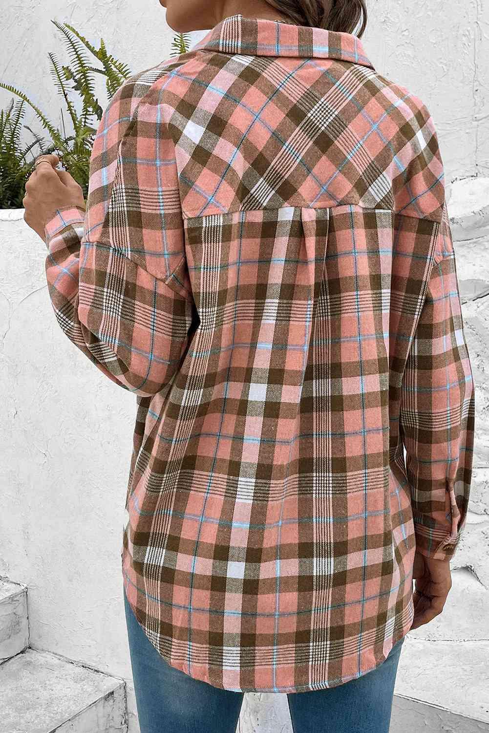 a woman wearing a pink and brown plaid shirt