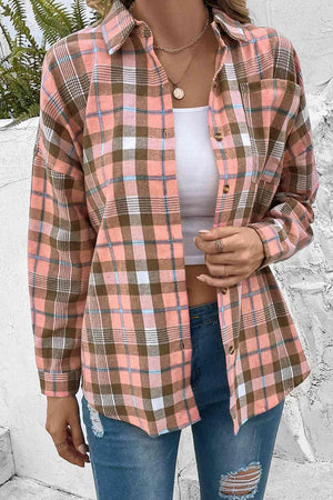 a woman wearing a plaid shirt and ripped jeans