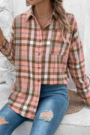 a woman wearing a plaid shirt and ripped jeans