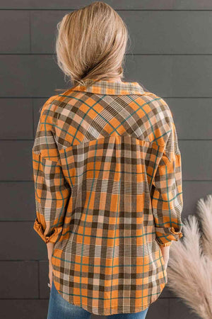 a woman wearing an orange and brown plaid shirt