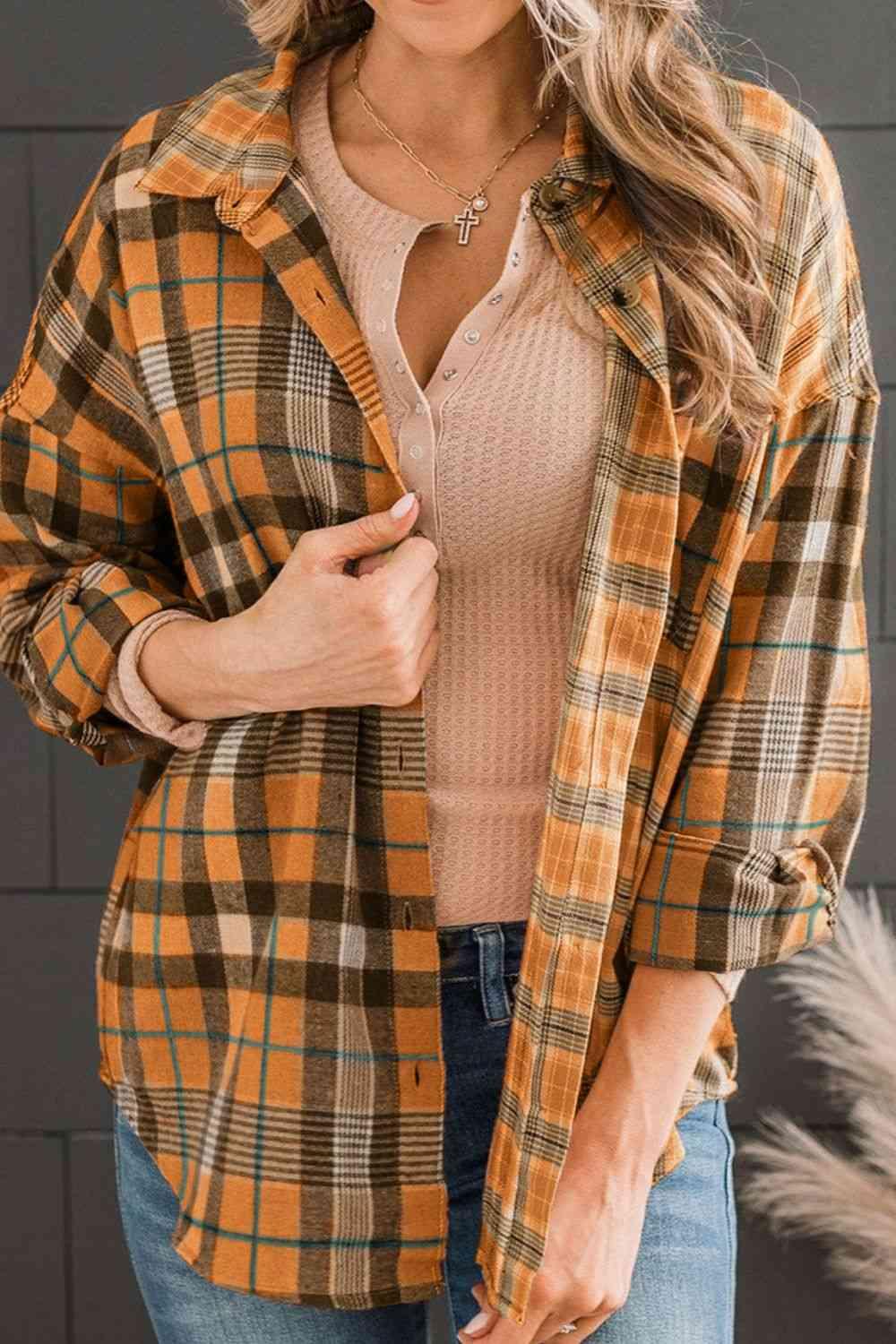 a woman wearing a plaid shirt and jeans