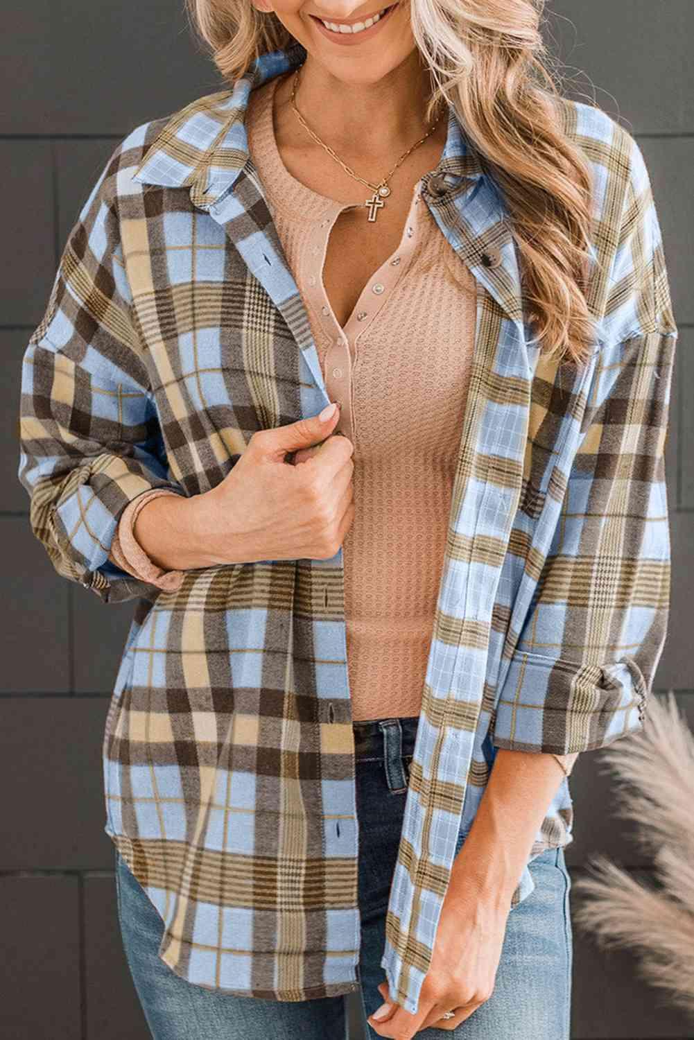 a woman wearing a plaid shirt and jeans