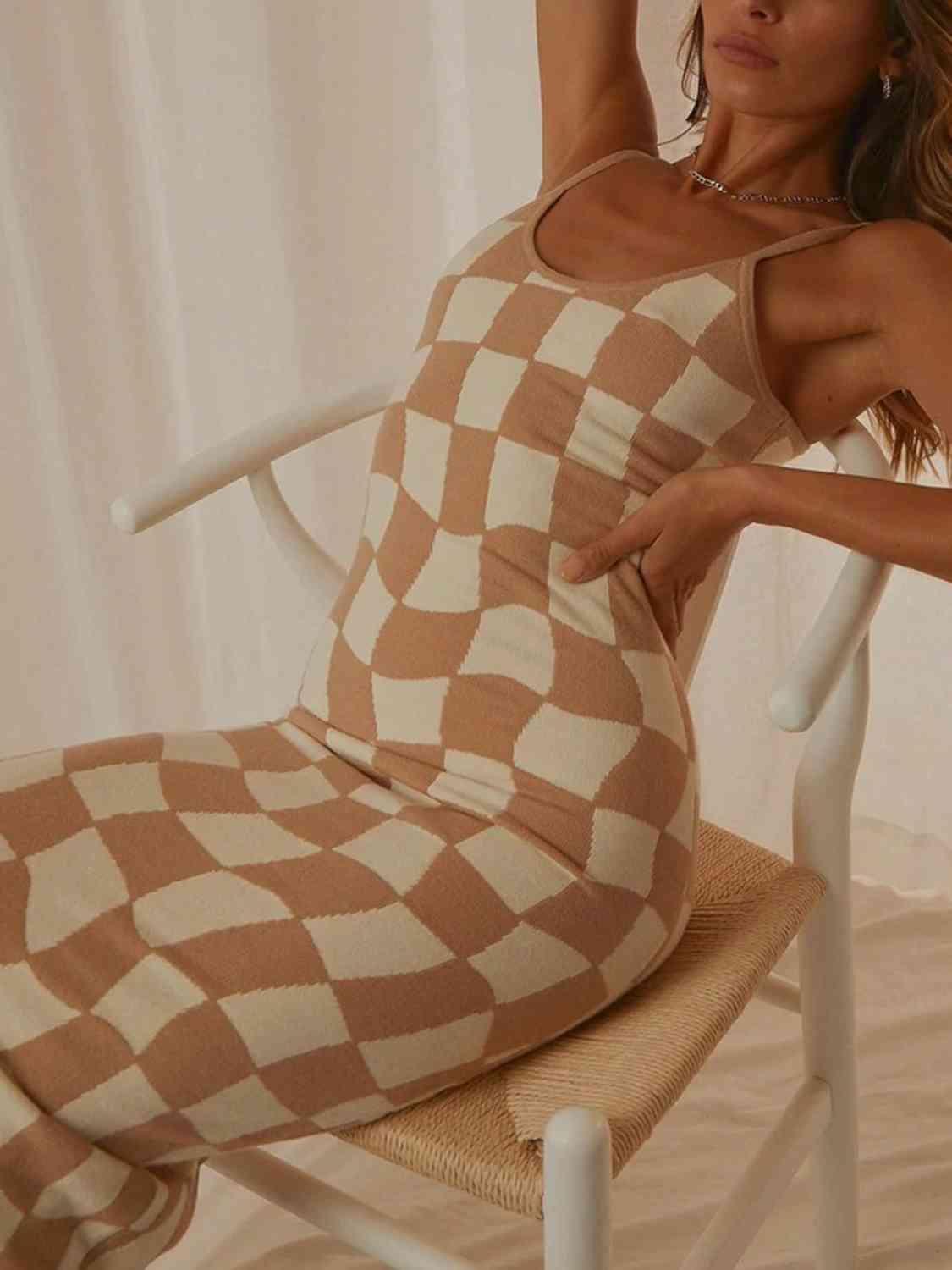 a woman in a brown and white checkered dress sitting on a chair
