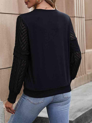 a woman wearing a black sweater and jeans