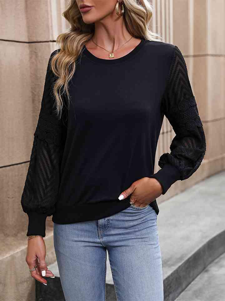 a woman wearing a black top and jeans