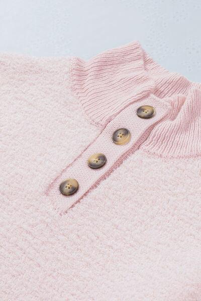 a close up of a pink sweater with buttons