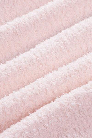 a close up of a white towel on a bed