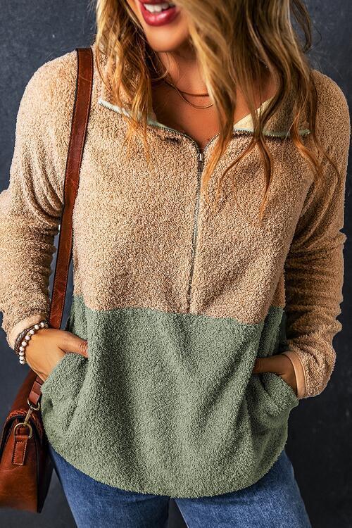 a woman wearing a brown and green sweater