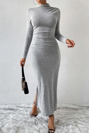 a woman wearing a grey dress and heels