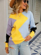a woman wearing a yellow and blue sweater