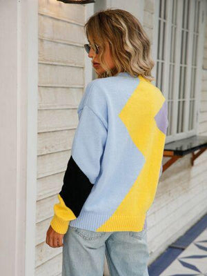a woman wearing a blue and yellow sweater