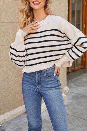 a woman wearing a striped sweater and jeans