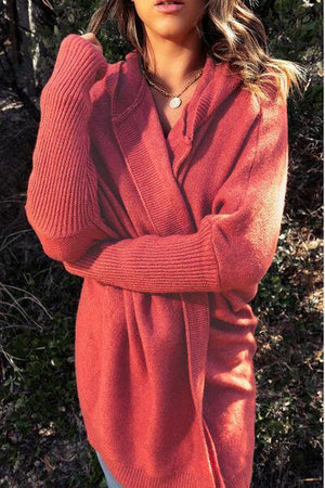 a woman in a red sweater posing for a picture